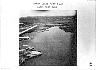 October 23, 1962: Low-level photograph of Komar guided-missile  patrol boats at Mariel port. Post-crisis review by NPIC revealed the Soviet  nuclear warhead processing base at the end of the runway  to the left.