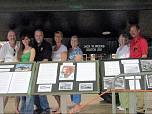 The Weeks Family and Owen Miller posing with the A-12 and the Roadrunner display